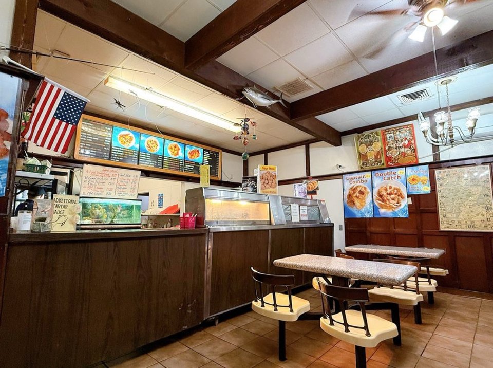 Fast-food seafood counter with fried dishes.