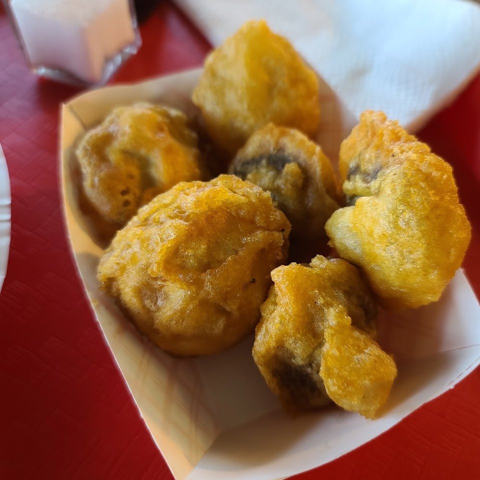 Counter menu with fried seafood and tartar sauce.