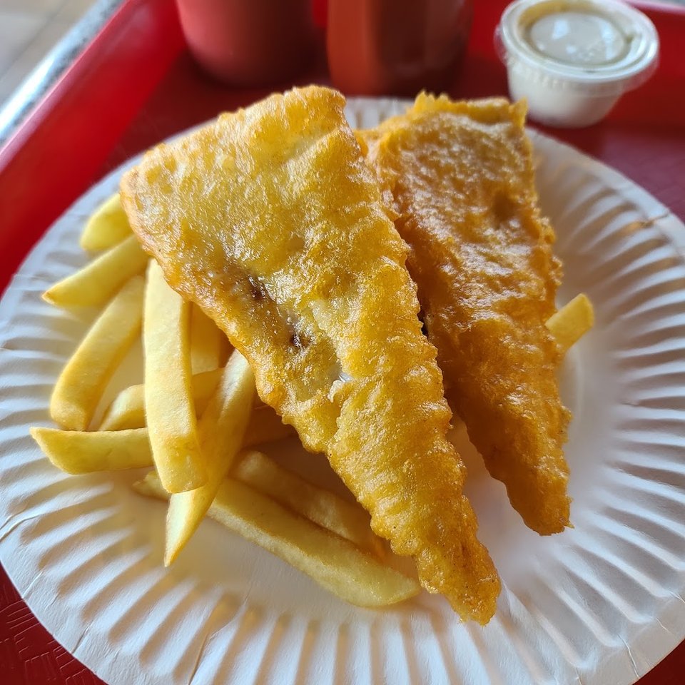 Counter menu with fried seafood and tartar sauce.