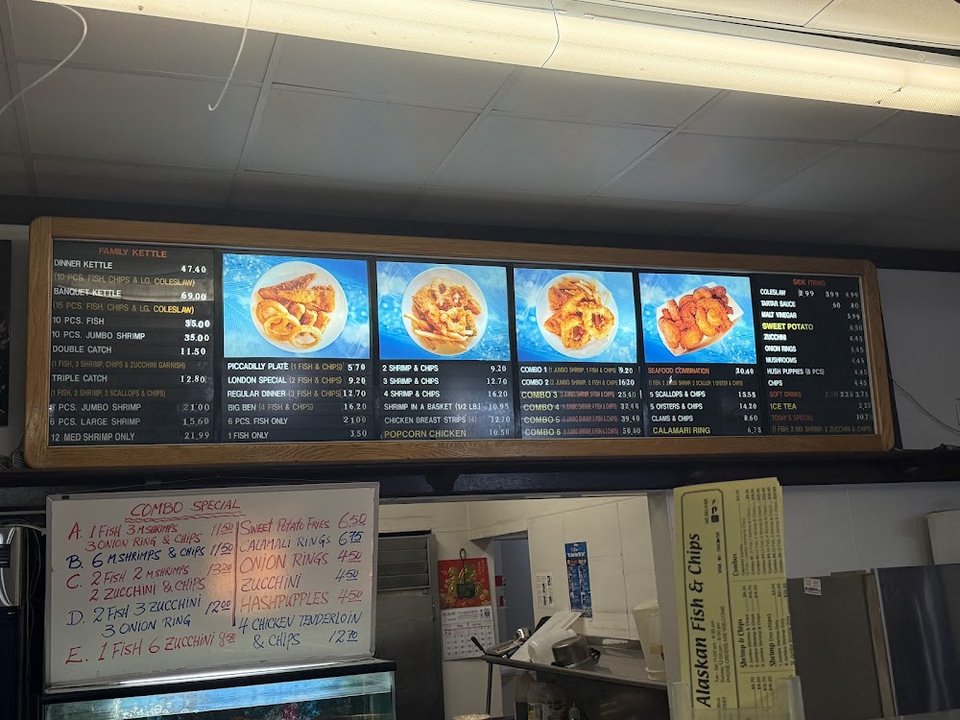 Counter menu with fried seafood and tartar sauce.