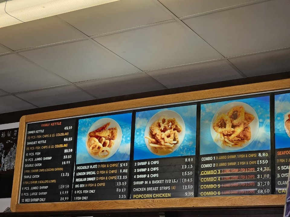 Menu board with fish, shrimp, and side items.