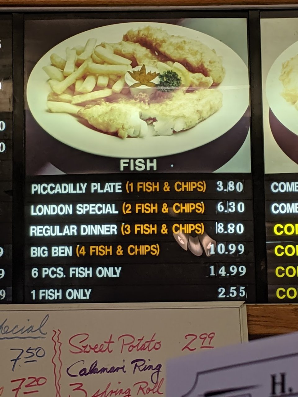 Menu board with fish, shrimp, and side items.