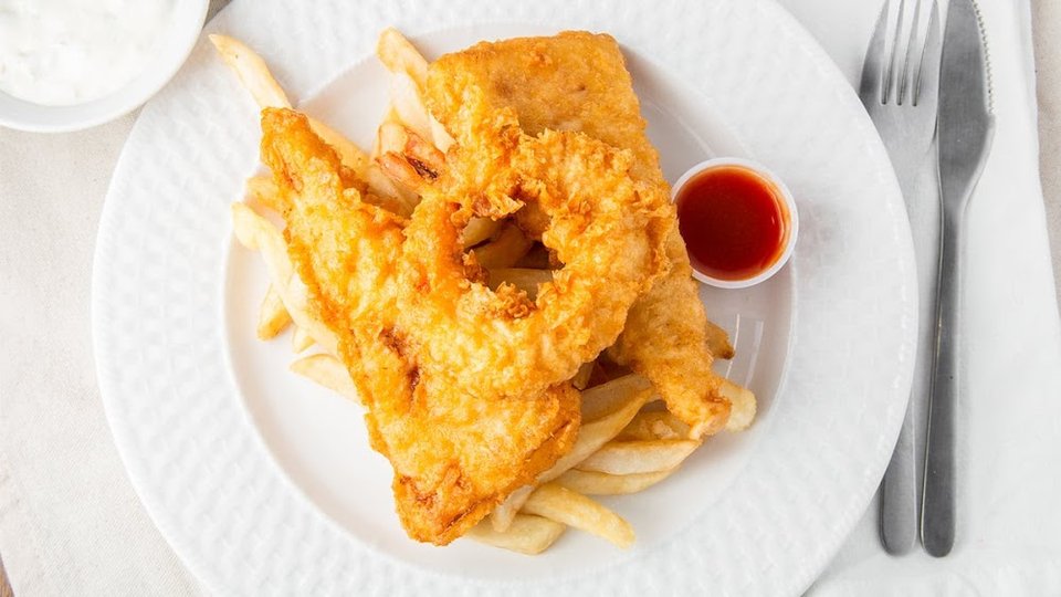Counter menu with fried seafood and tartar sauce.
