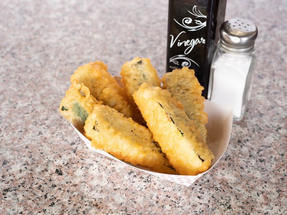 Counter menu with fried seafood and tartar sauce.